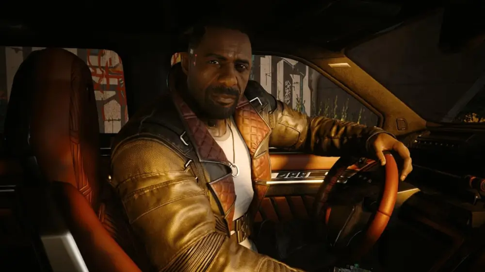 Cyberpunk 2077 Ultimate Edition אחד השחקנים יושב בתוך המכונית עם יד על ההגה