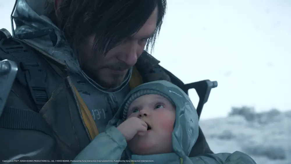 Death Stranding 2: On The Beach סם מחזיק תינוק בידיו